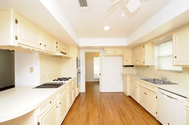 1110 Holly Dr, Conroe, TX 77301 - kitchen with visible vents, a sink, light wood-style floors, a ceiling fan, and appliances with stainless steel finishes