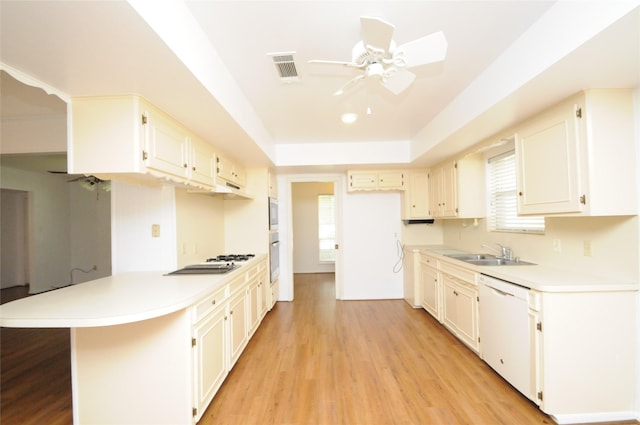 1110 Holly Dr, Conroe, TX 77301 - kitchen featuring a sink, white dishwasher, a peninsula, and a wealth of natural light