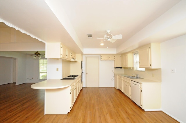 1110 Holly Dr, Conroe, TX 77301 - kitchen featuring a sink, a ceiling fan, a peninsula, and dishwasher