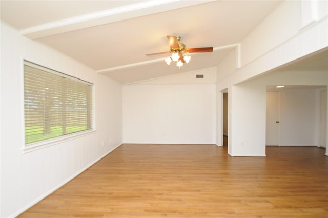 1110 Holly Dr, Conroe, TX 77301 - empty room with a ceiling fan, vaulted ceiling, visible vents, and light wood-style floors