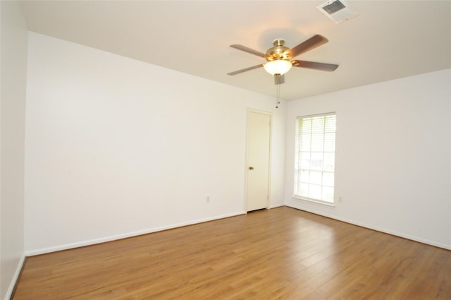 1110 Holly Dr, Conroe, TX 77301 - empty room with visible vents, light wood-style flooring, ceiling fan, and baseboards