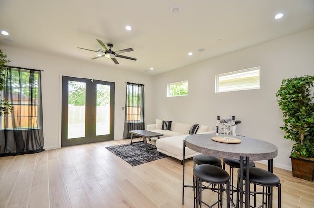 living room featuring a ceiling fan, french doors, light wood-style flooring, recessed lighting, and baseboards