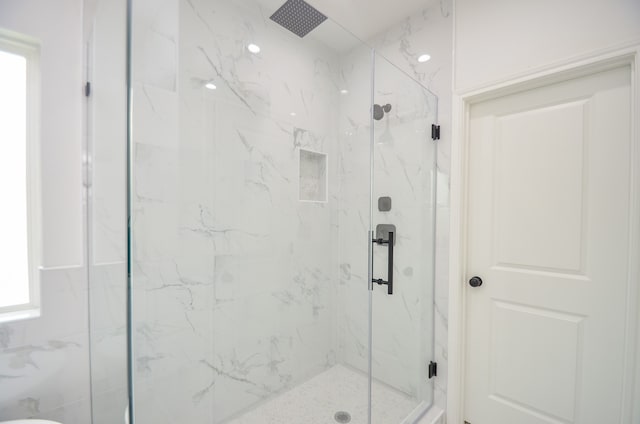 full bathroom featuring a marble finish shower