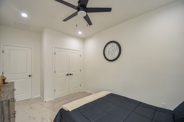 bedroom featuring light colored carpet, baseboards, recessed lighting, a closet, and a ceiling fan