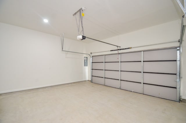 garage with a garage door opener, recessed lighting, and baseboards