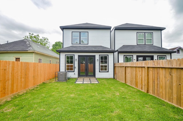 rear view of house featuring french doors and central AC