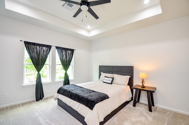 bedroom featuring carpet flooring, baseboards, recessed lighting, a raised ceiling, and a ceiling fan