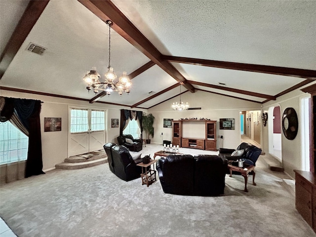 living room featuring an inviting chandelier, lofted ceiling with beams, carpet flooring, a textured ceiling, and visible vents
