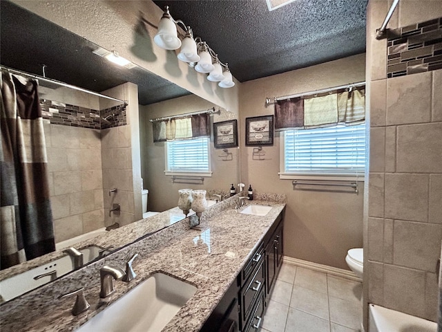 full bath with toilet, a textured ceiling, a sink, and tile patterned flooring