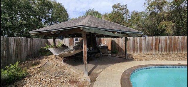 view of swimming pool featuring a fenced in pool, a gazebo, a fenced backyard, and a patio area