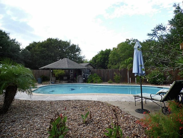 view of swimming pool featuring a fenced backyard, a gazebo, a fenced in pool, and a patio