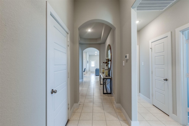2411 Ocean Key Dr, La Marque, TX 77568 - corridor with arched walkways, light tile patterned floors, visible vents, and baseboards