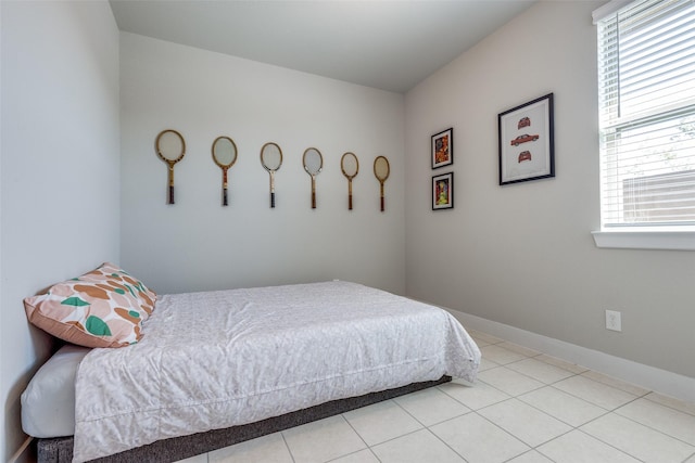 2411 Ocean Key Dr, La Marque, TX 77568 - bedroom featuring tile patterned floors and baseboards