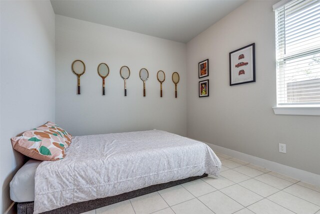2411 Ocean Key Dr, La Marque, TX 77568 - bedroom featuring tile patterned floors and baseboards