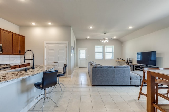 2411 Ocean Key Dr, La Marque, TX 77568 - living room with ceiling fan, vaulted ceiling, light tile patterned floors, and recessed lighting