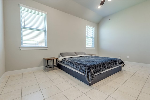 2411 Ocean Key Dr, La Marque, TX 77568 - bedroom with ceiling fan, light tile patterned flooring, baseboards, and vaulted ceiling
