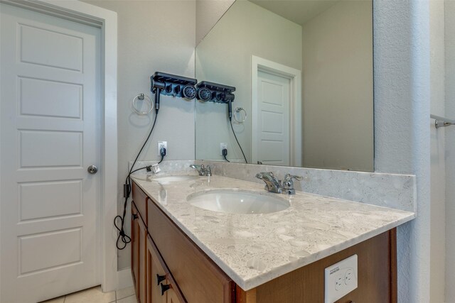 2411 Ocean Key Dr, La Marque, TX 77568 - bathroom featuring a sink, tile patterned floors, and double vanity