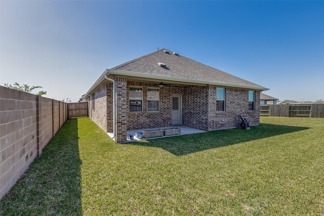 2411 Ocean Key Dr, La Marque, TX 77568 - rear view of property with a yard, a fenced backyard, a patio area, brick siding, and a shingled roof