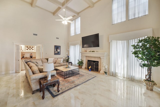living area with a high ceiling, marble finish floor, visible vents, a ceiling fan, and beamed ceiling
