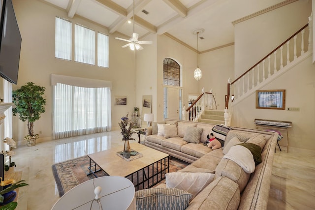 living area with beamed ceiling, stairway, a towering ceiling, and coffered ceiling