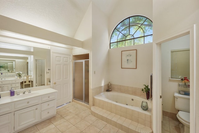 full bathroom with tile patterned floors, toilet, a shower stall, a tub with jets, and vanity