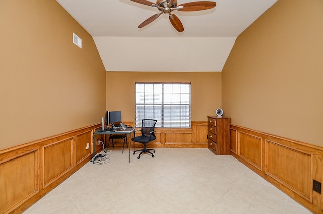 home office with lofted ceiling, visible vents, a wainscoted wall, and ceiling fan