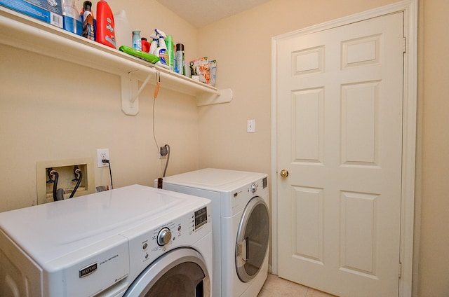 washroom with separate washer and dryer, laundry area, and light tile patterned flooring