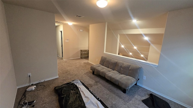 living area with baseboards, visible vents, and carpet