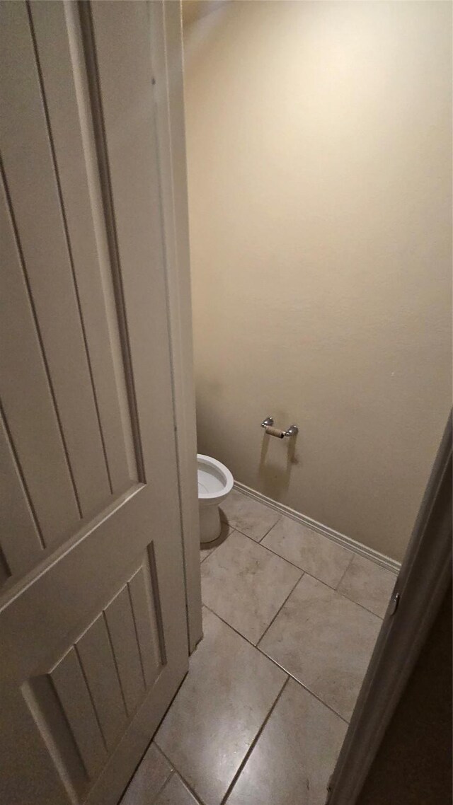 bathroom featuring tile patterned floors and toilet