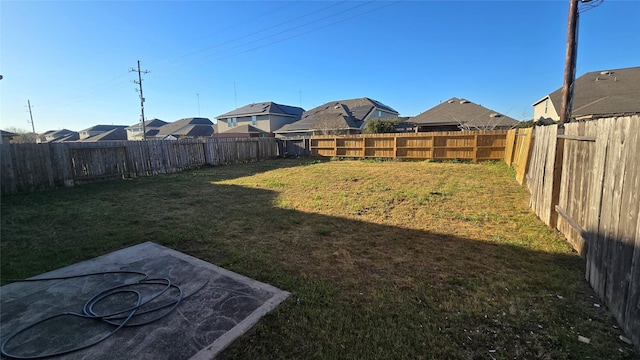 view of yard featuring a residential view and a fenced backyard