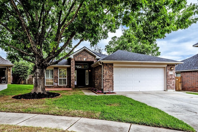 23222 Drywood Crossing Ct, Spring, TX 77373 - view of front of home featuring concrete driveway, an attached garage, brick siding, and roof with shingles