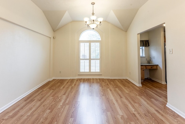 23222 Drywood Crossing Ct, Spring, TX 77373 - empty room featuring a chandelier, light wood finished floors, lofted ceiling, and baseboards
