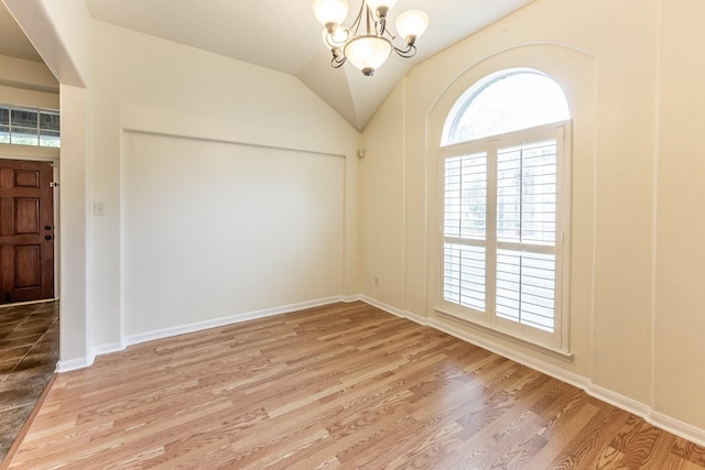 23222 Drywood Crossing Ct, Spring, TX 77373 - unfurnished room featuring a chandelier, light wood-style floors, vaulted ceiling, and baseboards