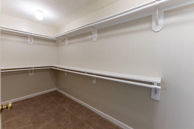 23222 Drywood Crossing Ct, Spring, TX 77373 - walk in closet with dark tile patterned flooring