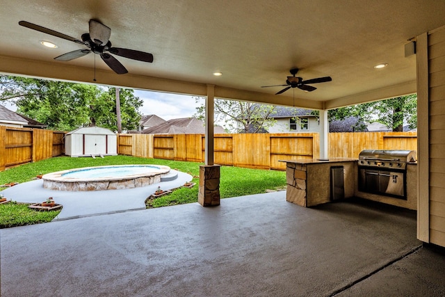 23222 Drywood Crossing Ct, Spring, TX 77373 - view of patio / terrace with ceiling fan, a fenced backyard, a storage unit, an outbuilding, and area for grilling