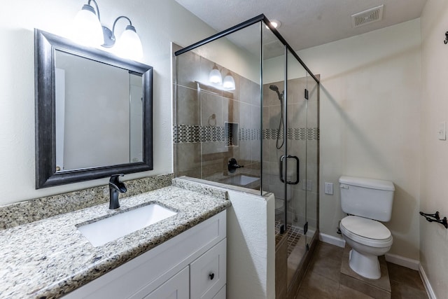 23222 Drywood Crossing Ct, Spring, TX 77373 - bathroom featuring toilet, tile patterned flooring, a stall shower, vanity, and baseboards