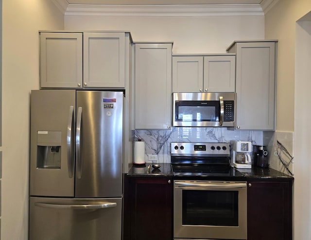 100 Willard St Unit 46, Houston, TX 77006 - kitchen with ornamental molding, backsplash, appliances with stainless steel finishes, and dark stone countertops