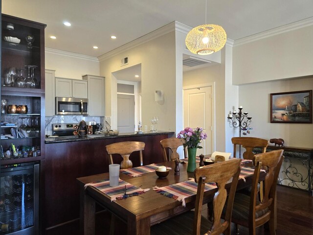 100 Willard St Unit 46, Houston, TX 77006 - dining space featuring dark wood finished floors, ornamental molding, visible vents, recessed lighting, and wine cooler