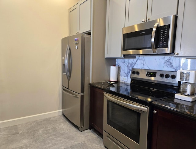 100 Willard St Unit 46, Houston, TX 77006 - kitchen with tasteful backsplash, baseboards, dark stone countertops, and stainless steel appliances