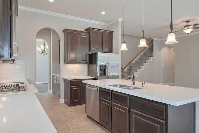 13207 Spurlin Meadow Dr, Tomball, TX 77377 - kitchen featuring light countertops, stainless steel appliances, arched walkways, and a sink