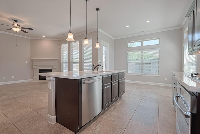kitchen featuring open floor plan, ceiling fan, light countertops, a sink, and appliances with stainless steel finishes