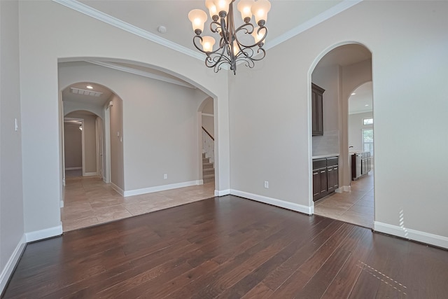 13207 Spurlin Meadow Dr, Tomball, TX 77377 - spare room featuring an inviting chandelier, ornamental molding, wood-type flooring, and visible vents