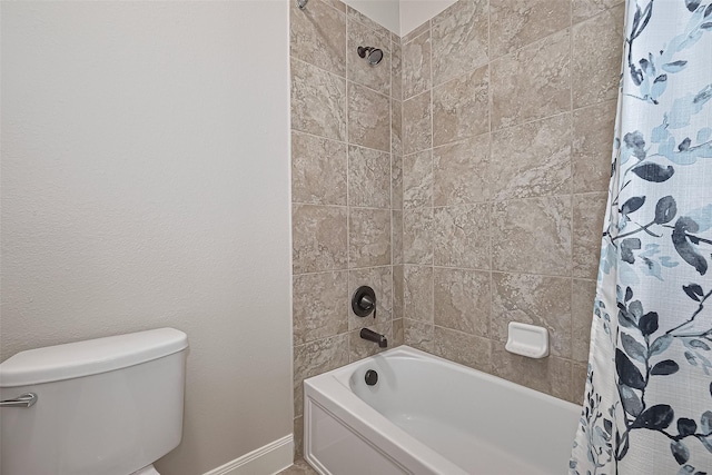 full bathroom with toilet, baseboards, and shower / bath combination with curtain