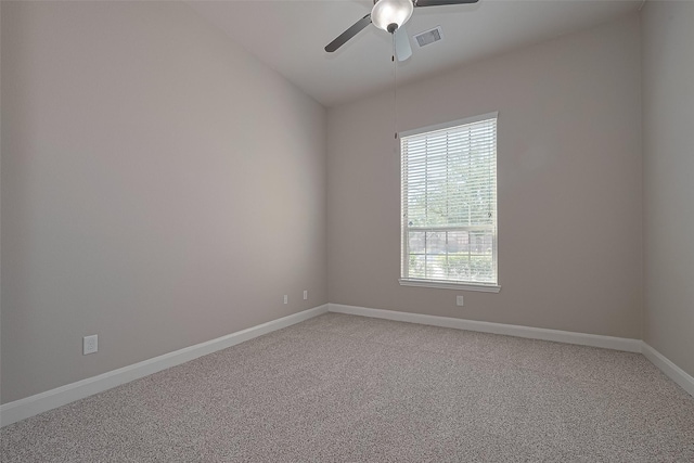 unfurnished room featuring ceiling fan, light colored carpet, baseboards, vaulted ceiling, and visible vents