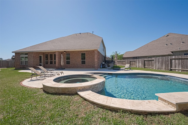 view of swimming pool with a lawn, a fenced backyard, a patio area, and a pool with connected hot tub
