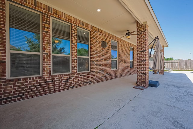view of patio with fence and a ceiling fan
