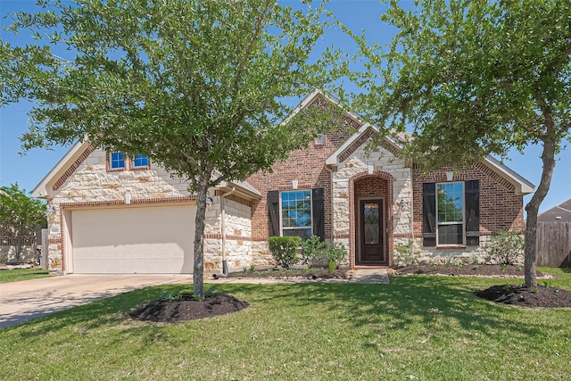 traditional home featuring fence, a front yard, stone siding, and concrete driveway