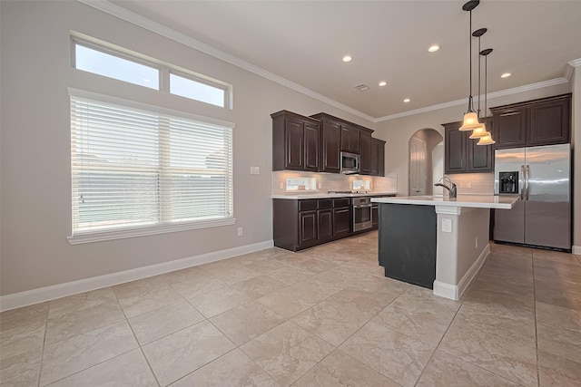 kitchen featuring decorative backsplash, arched walkways, light countertops, ornamental molding, and stainless steel appliances