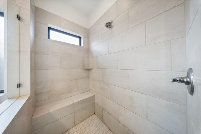 bathroom with a tile shower