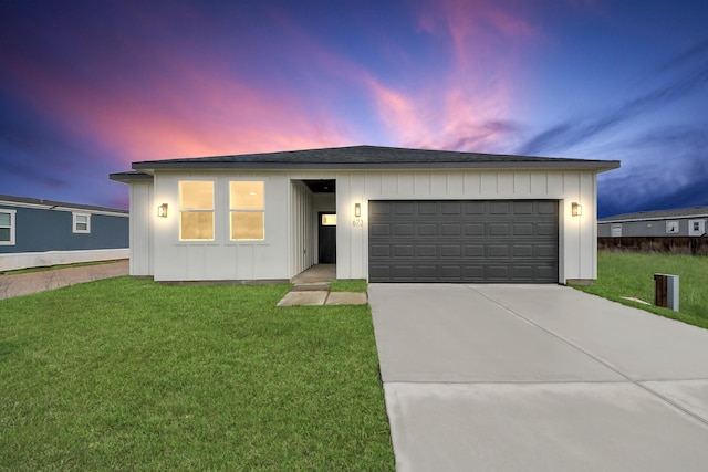 673 Rd 5822, Cleveland, TX 77327 - ranch-style home featuring driveway, a front lawn, a garage, and board and batten siding
